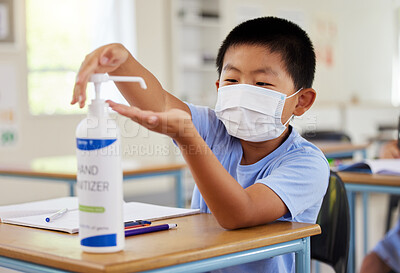 Buy stock photo Covid, hand sanitizer and school student with mask cleaning, protecting and staying safe in education classroom. Small, little and cute asian boy in learning in study class preventing spread of virus