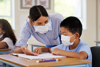 Buy stock photo Covid, students and education teacher helping learning children in school classroom to answer math question. Woman with face mask teaching asian boy in lesson with diverse class of kids or classmates