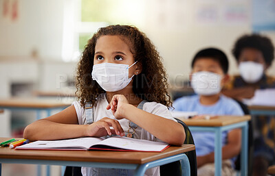 Buy stock photo School student with covid learning in class, wearing mask to protect from virus and looking concentrated on education in classroom. Little girl sitting at desk, studying and listening during pandemic