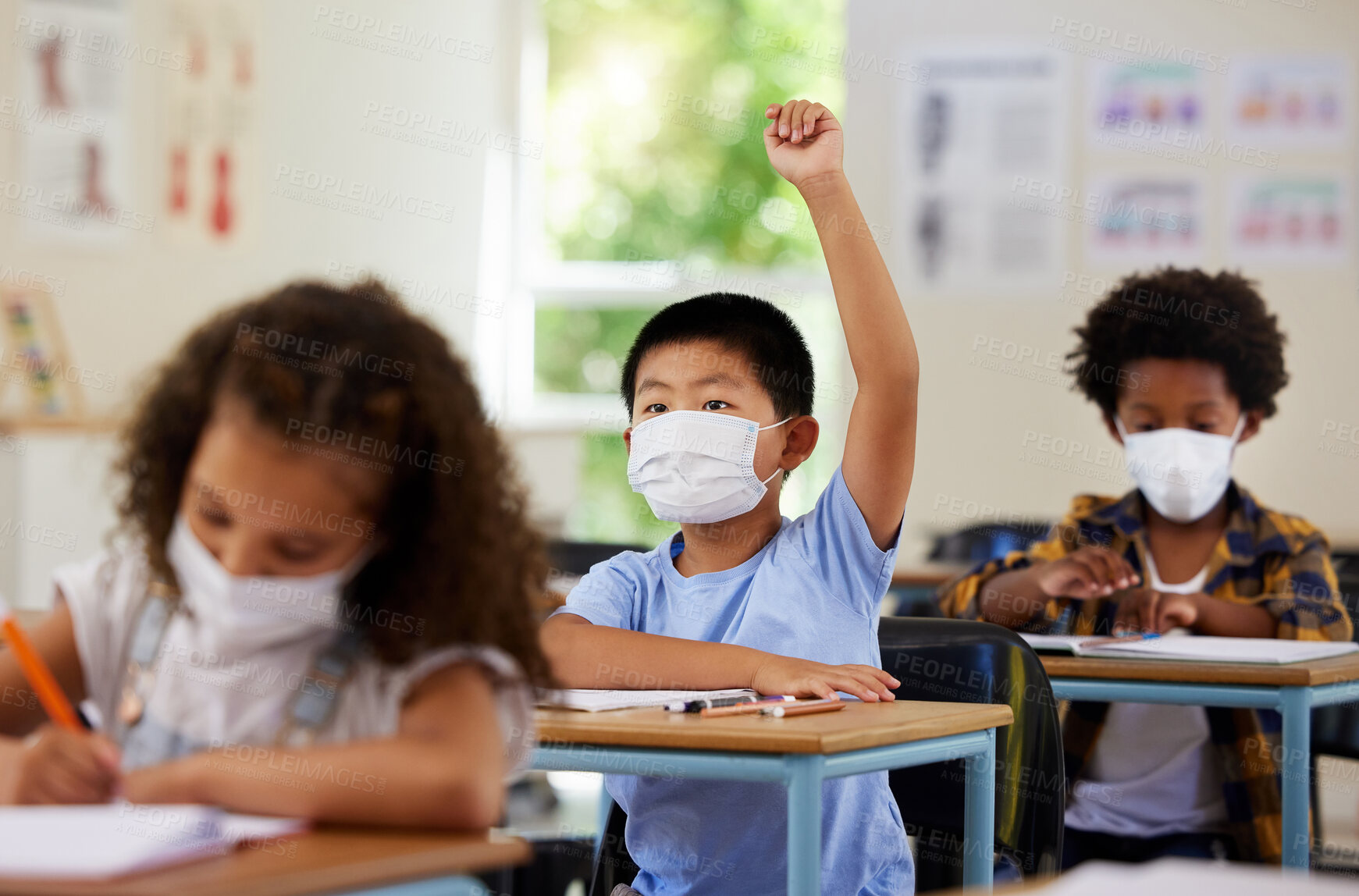 Buy stock photo School student raising hand to volunteer, participate and answer question at class lesson in covid pandemic. Curious, smart and clever young boy wearing a mask for education and learning