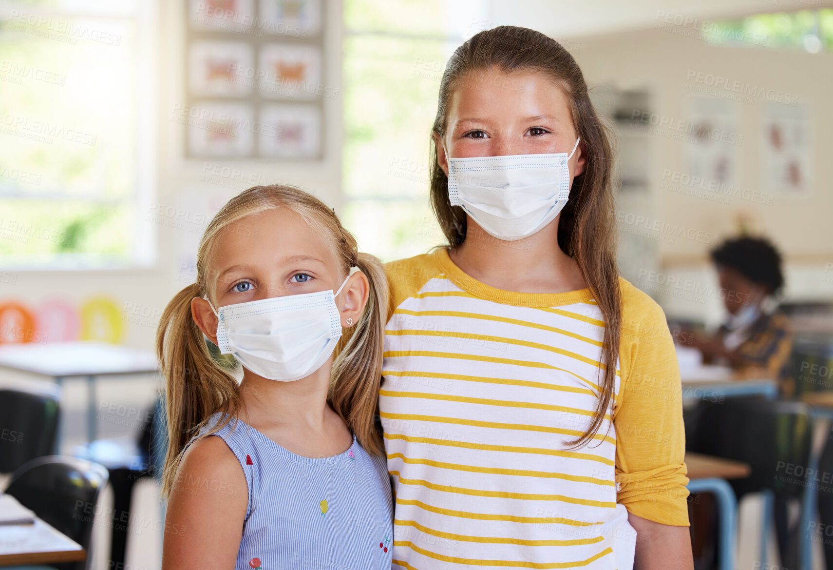 Buy stock photo Young kids learning in classroom, after covid pandemic, wearing face masks together in school. Portrait of little girl students, waiting for their education lesson to begin, with their friends