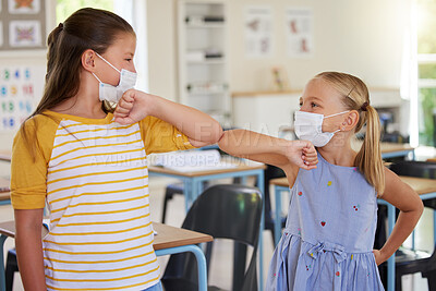 Buy stock photo Covid greeting, elbow bump and mask wearing with little girl students standing in class at school. Study, education and safety in a classroom with a female child and her friend bumping elbows