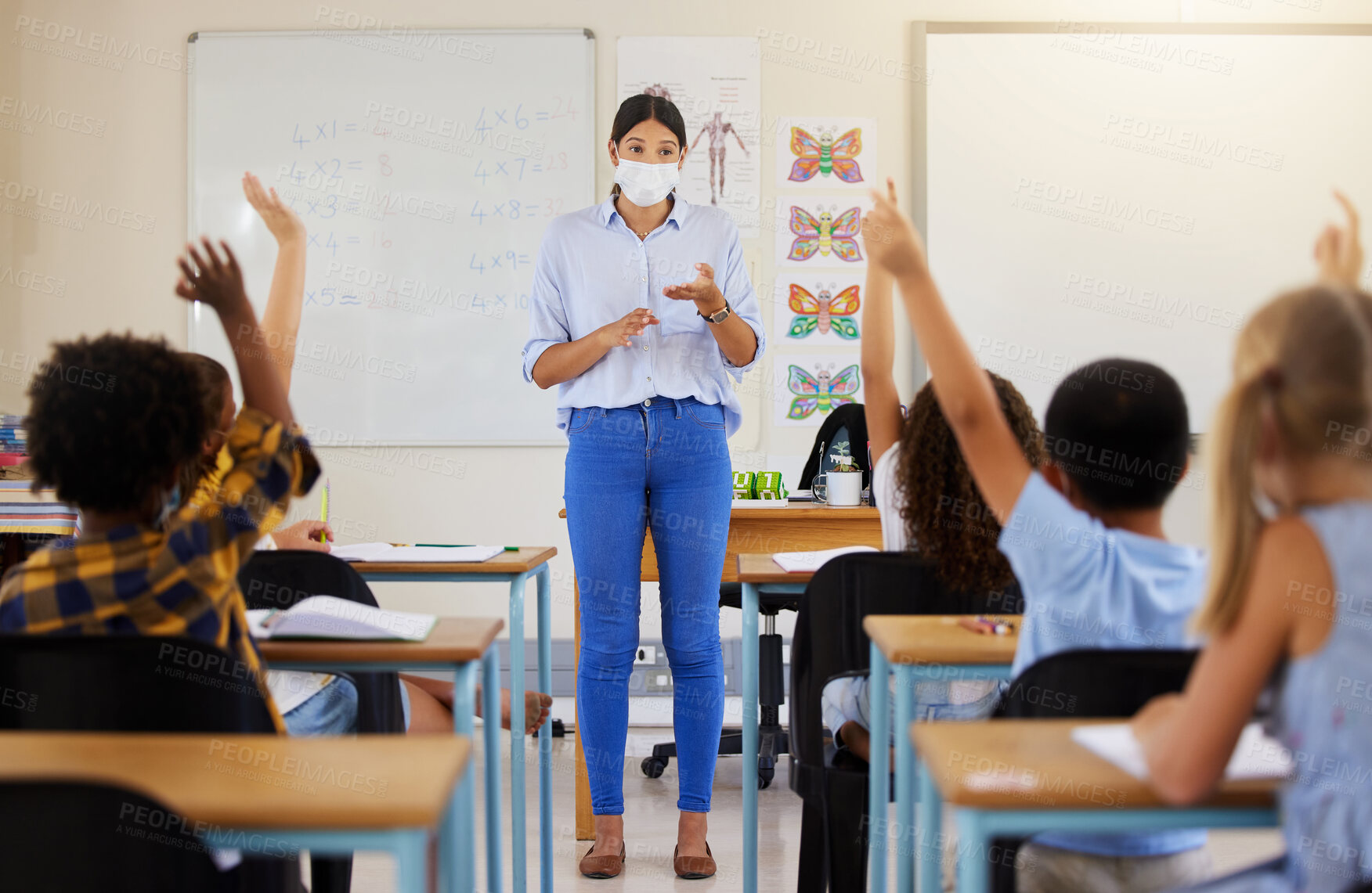 Buy stock photo Teacher asking questions to school kids who are eager, smart and clever for education in covid pandemic. Students raising hand to volunteer, join and answer educator in class lesson for learning