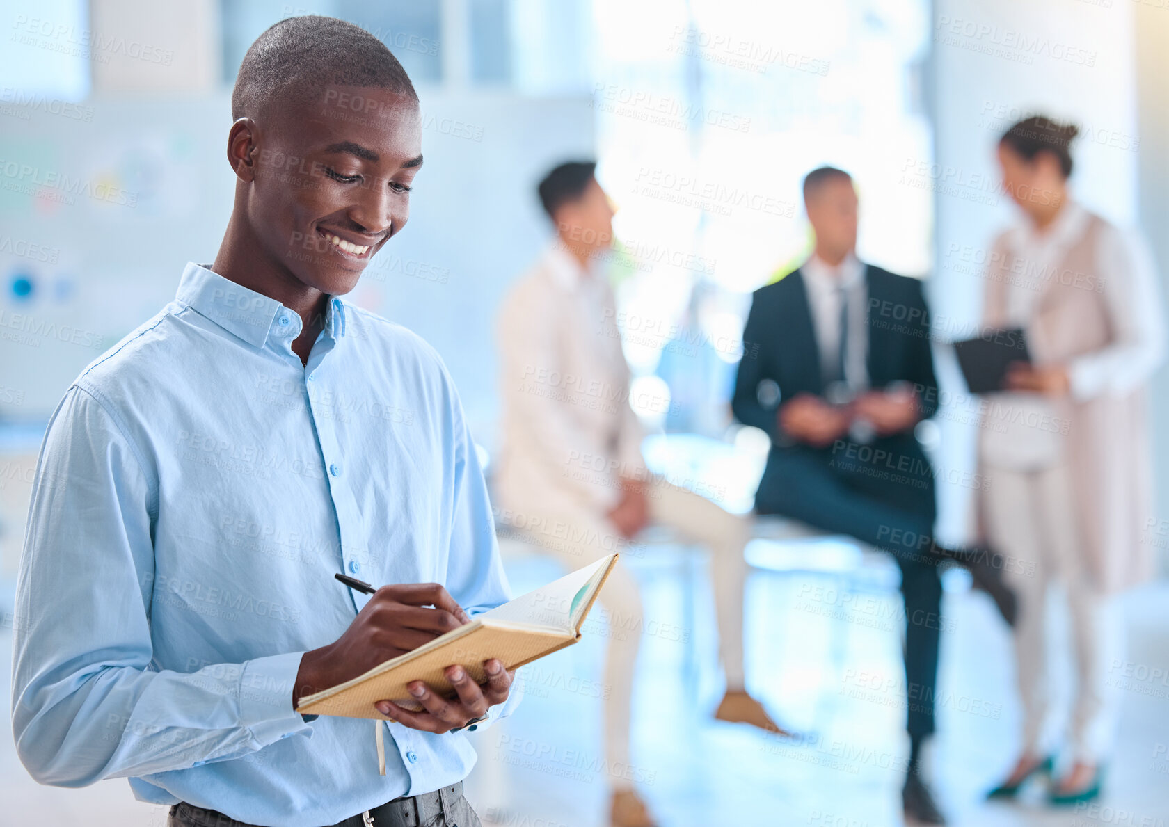 Buy stock photo Assistant writing notes in a notebook for a team of executive people and is happy with a positive mindset, vision and mission. African American business man using a journal or diary for his schedule