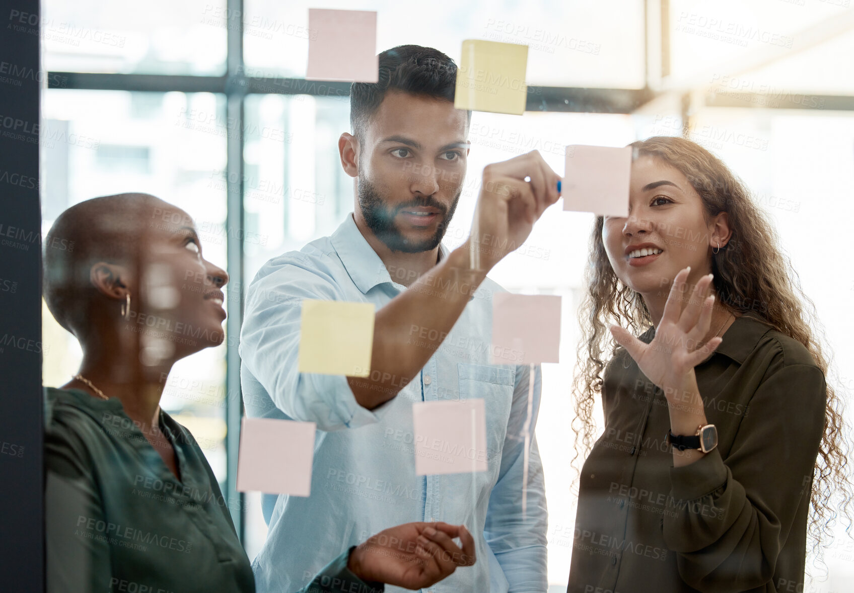 Buy stock photo Team strategy meeting on research, post it on glass wall and group work planning together. Business people brainstorming analytics vision think tank ideas, collaboration thinking and sticky notes