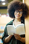Library, books and education with a woman student reading in a bookstore on university or college campus. Study, scholarship and learning for an exam and test for knowledge, growth and development