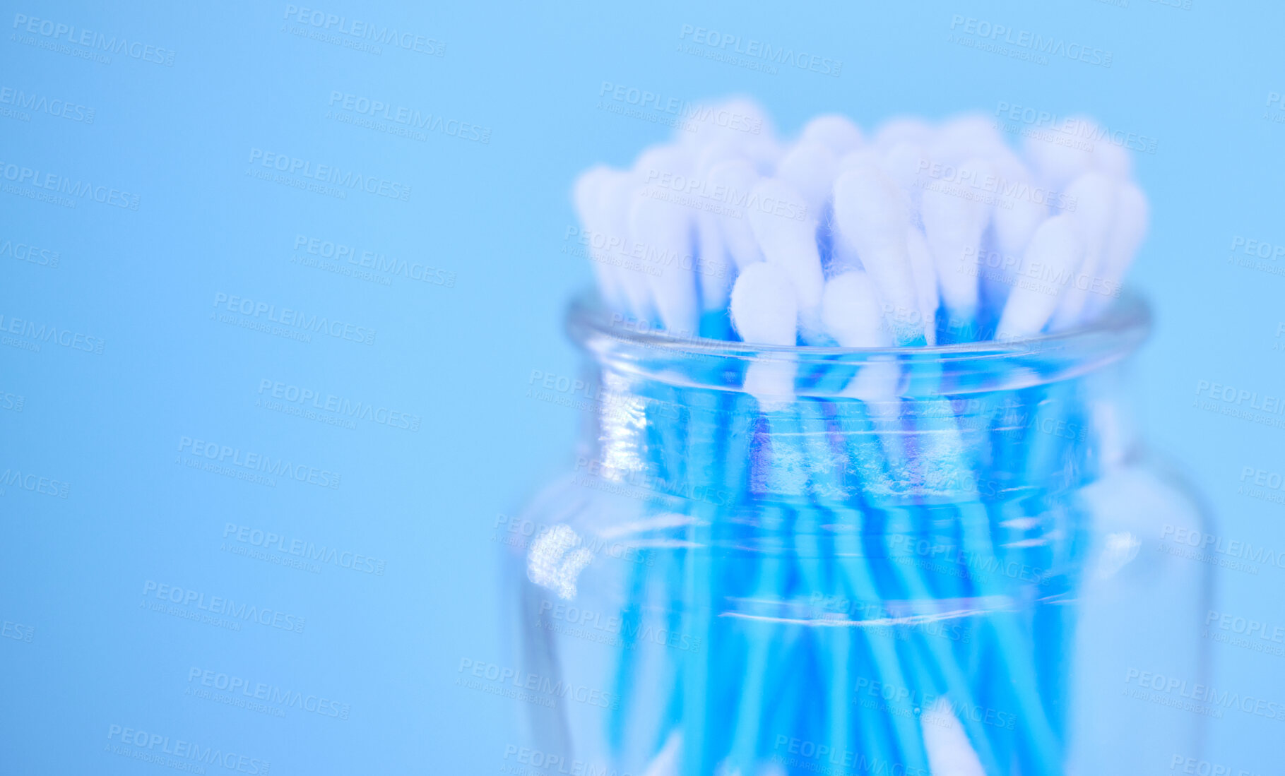 Buy stock photo Glass container with cotton makeup cosmetic swab buds, self cleaning ear canal and environment recycle. Covid nasal test, skincare health safety and climate change on blue background closeup