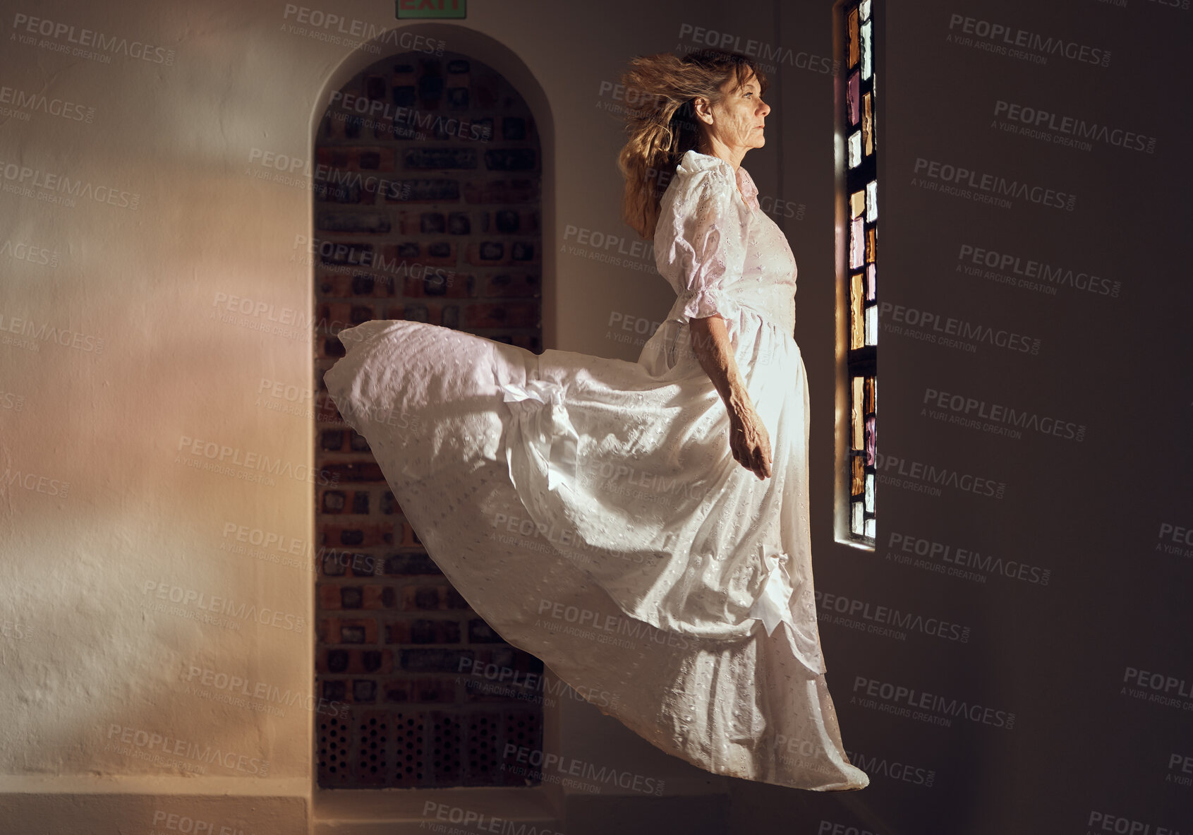 Buy stock photo Ghost of senior woman, looking at stained glass and floating over floor of building or cathedral. Elderly soul, phantom or dead spirit staring at beautiful window at a chapel or church after funeral
