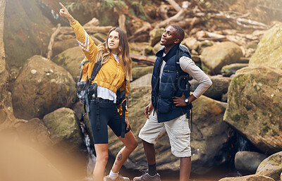 Buy stock photo Fitness hiking, nature and couple in exercise workout together looking at paths to take on a rocky trail in the outdoors. Interracial man and woman pointing for motivation and navigation during hike.