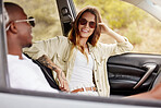 Happy couple on road trip, holiday or vacation in the driving car in summer. Cheerful and travel man and woman enjoying, having fun in a vehicle while on a road journey to a romantic destination