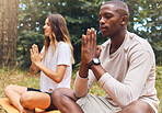 Yoga, man and woman in prayer hand pose together in nature, grass and outdoors. Zen, meditation and athletic friends doing pilates outside on the ground or field for health, fitness and wellness.