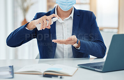 Buy stock photo Businessman spray cleaning with a covid mask while working in an office. Entrepreneur cleaning and disinfecting his hands to prevent the spread of germs, corona and infection in the covid pandemic