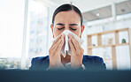 Covid, virus and sick with a business woman blowing her nose with a tissue and sneezing while working in her office. Allergies, sneeze and flu with a female employee suffering from a cold at work