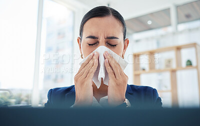 Buy stock photo Covid, virus and sick with a business woman blowing her nose with a tissue and sneezing while working in her office. Allergies, sneeze and flu with a female employee suffering from a cold at work