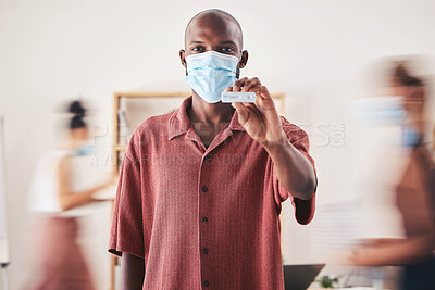 Buy stock photo Covid, rapid antigen test and face mask while standing and showing negative medical results. Portrait of a black man looking happy after coronavirus health screening during pandemic at his workplace
