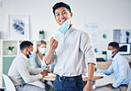 Portrait of happy Asian businessman with a mask during covid in an office meeting with team in the background. Leader, ceo or manager with a smile for collaboration, teamwork or teamwork success