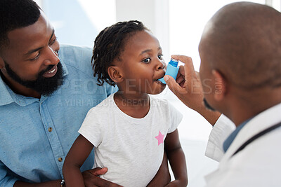 Buy stock photo Doctor helping a child patient with an asthma inhaler in his office at the medical clinic. Healthcare worker consulting a girl with chest or respiratory problems with pump in a children's hospital 