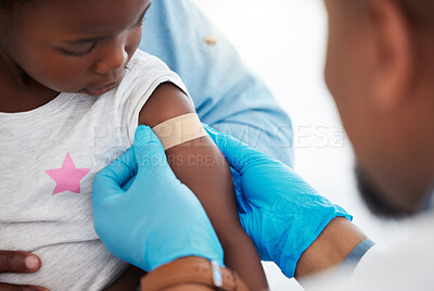 Buy stock photo Doctor, healthcare worker and medical professional with plaster on arm of sick child after covid vaccine, doing checkup after injury and protect from virus. African girl at clinic consultation
