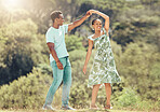 Love, freedom and celebration by couple dancing outdoors, loving romantic getaway and bonding. Happy black man and woman being playful and sweet, enjoying their relationship and having fun together