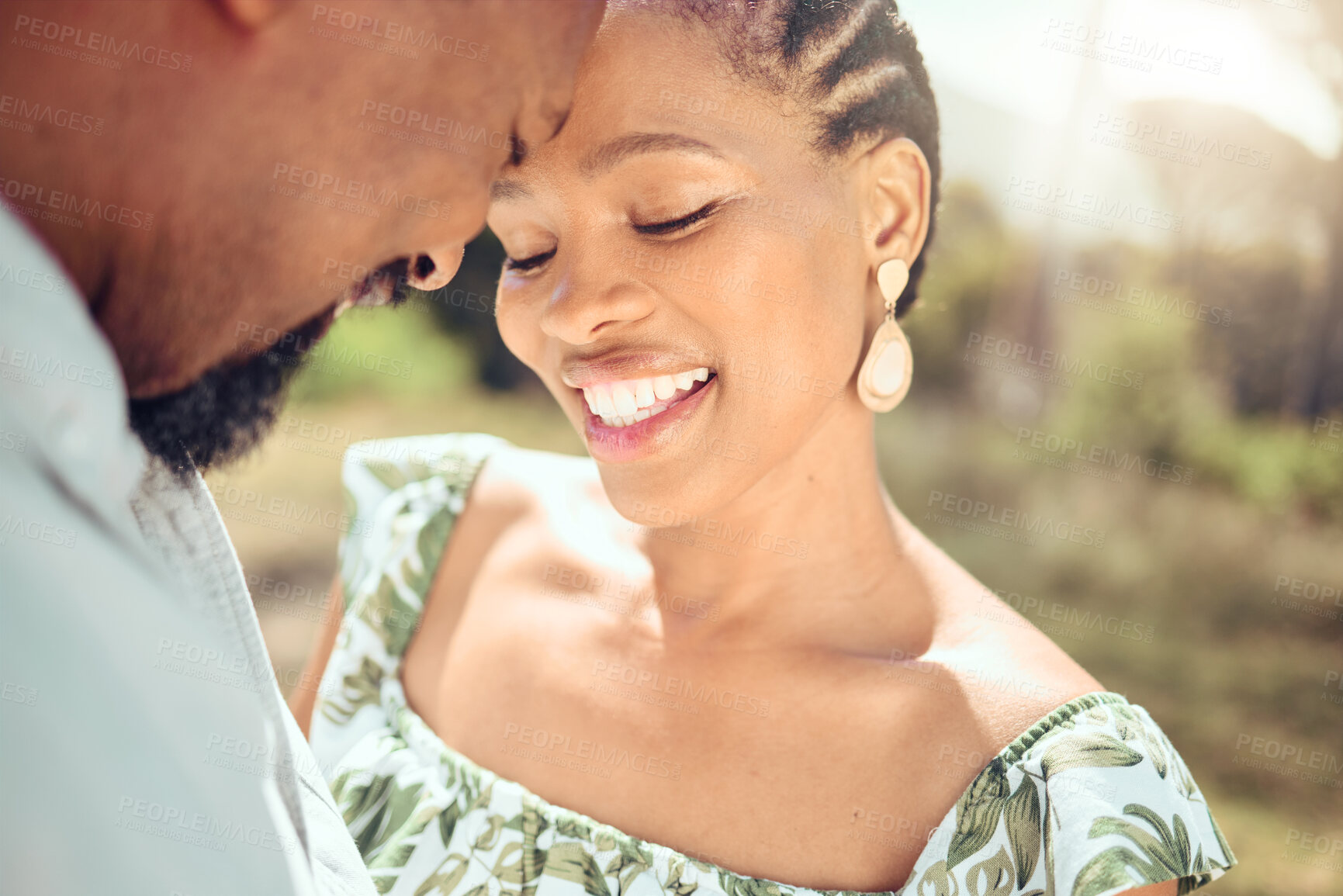 Buy stock photo Love, black couple and forehead touch in nature with a smile on holiday or date. Happy black man and woman, romantic African people or lovers bonding in affection together in the shining summer sun.
