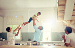 Family happy, home and father love of a man with his child in the air playing in a house kitchen. Generation of men smile at home with a fun time together and relax and comic mindset with sun shining