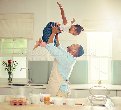 Buy stock photo Happy black father and daughter playing in a kitchen while cooking together, bonding and laughing. African American parent enjoying family time with his child, playful and having fun while baking