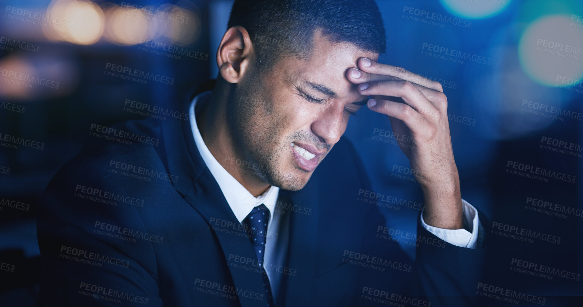 Buy stock photo Headache, stress and burnout with businessman working late night in corporate office building. Anxiety, mental health and migraine pain with audit, tax or risk company employee sitting at desktop