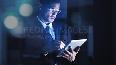 Buy stock photo Businessman working overtime on a digital tablet with glasses in a corporate modern office. Corporation manager reading company documents, data and statistics on an internet website with technology.