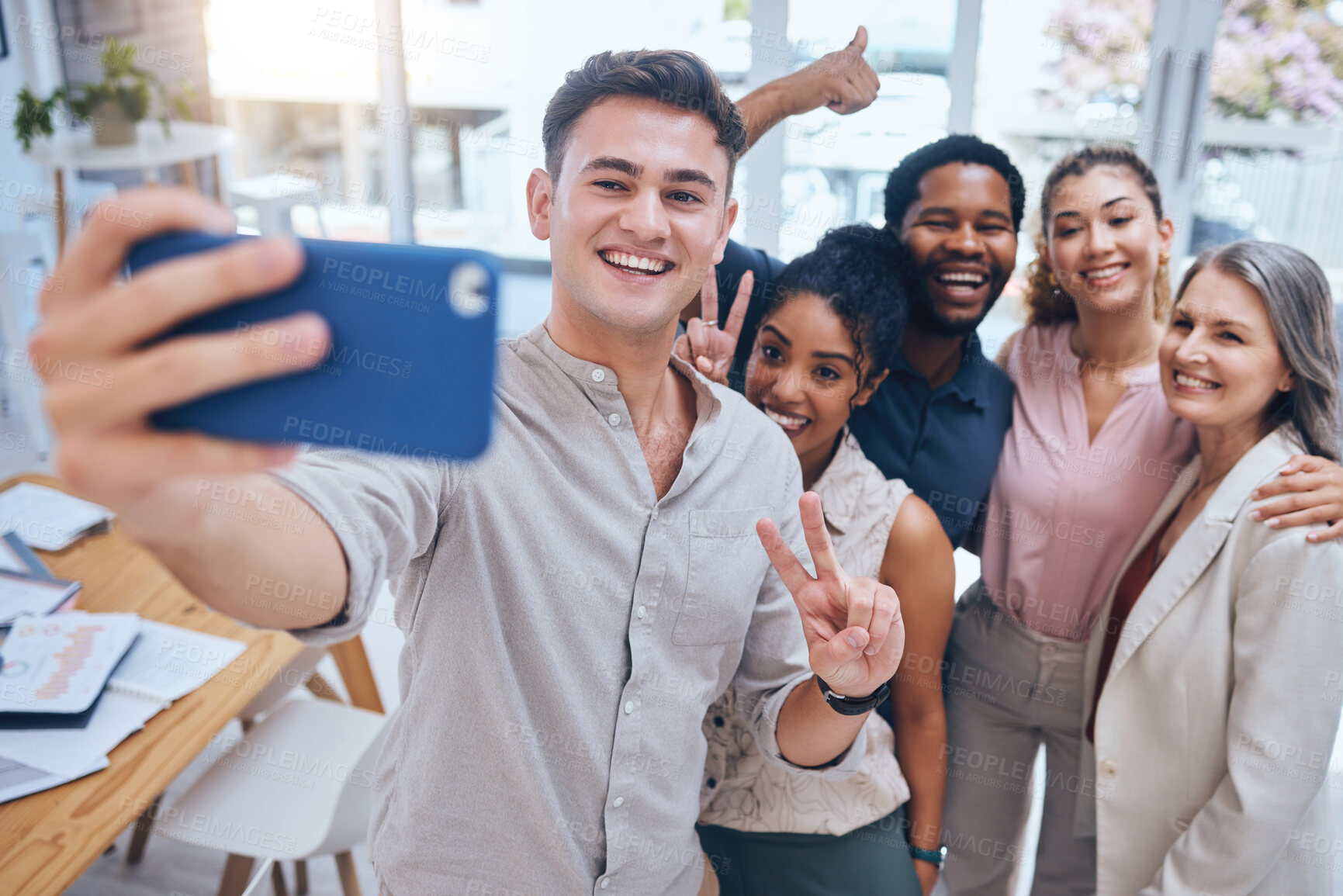 Buy stock photo Selfie, diversity and teamwork with happy business people showing peace sign in startup office. Positive workplace and employee engagement for motivation with healthy staff in a fun work environment