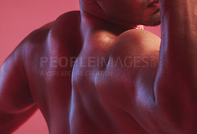 Buy stock photo Sexy man, strong back and muscle bodybuilder in nude, fitness and skin against colorful studio background. Naked, healthy and powerful guy closeup with shoulder strength, muscular and flexing arms