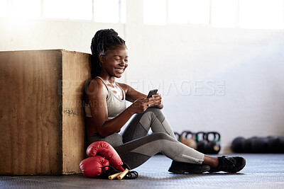 Buy stock photo Black woman boxer with phone in gym relax, wellness and exercise after sport, fitness and training with smile. Communication, health and happy sports girl on technology, mobile and smartphone.
