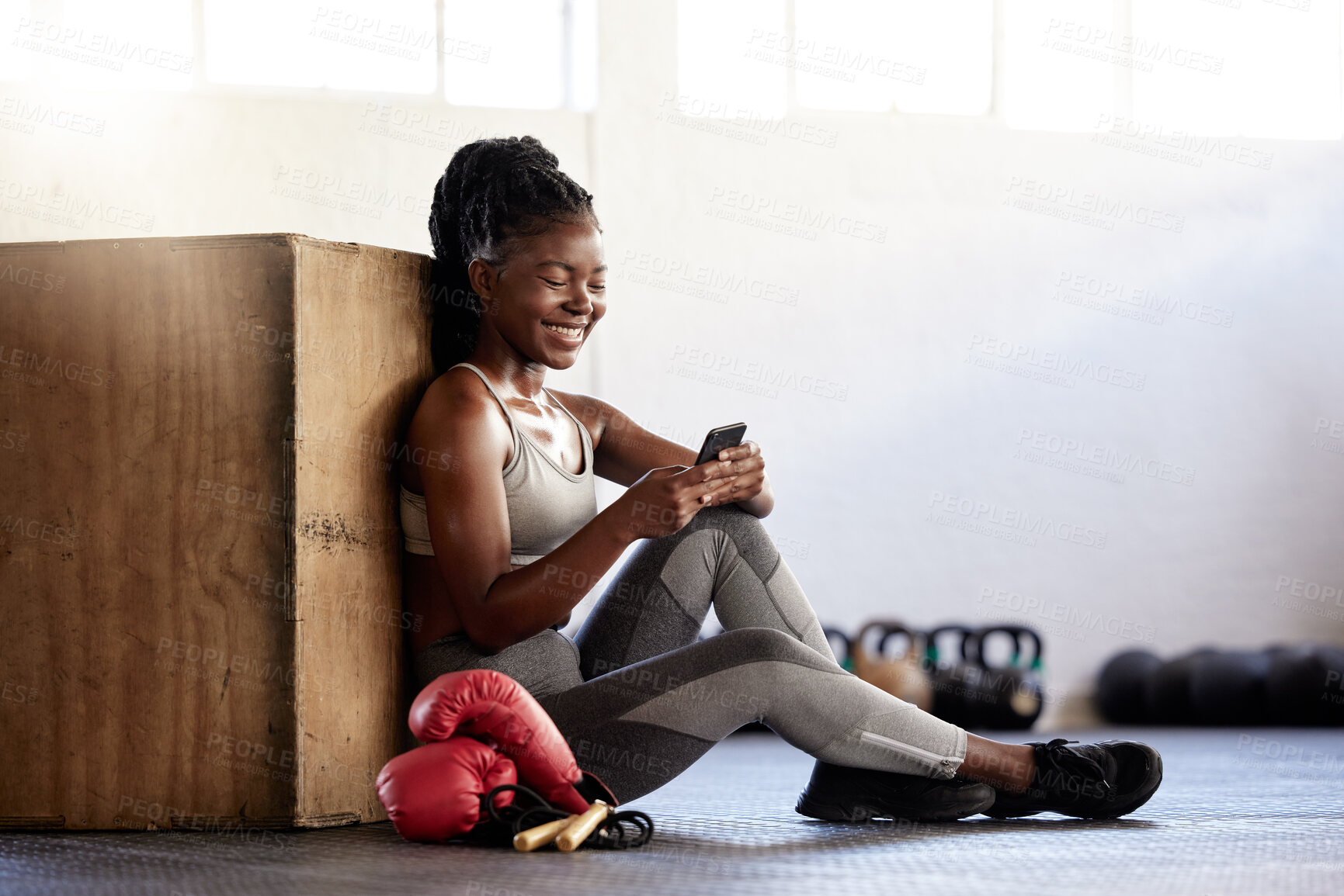 Buy stock photo Black woman boxer with phone in gym relax, wellness and exercise after sport, fitness and training with smile. Communication, health and happy sports girl on technology, mobile and smartphone.
