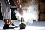 Woman powder hands, kettlebell fitness and ready for gym training, workout and exercise in healthy club. Bodybuilder athlete with power, dust and motivation prepared for heavy performance challenge 