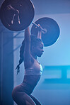 Weightlifting focus, motivation and fitness workout mindset of woman lifting weights at a gym. Female from Kenya working out, sports exercise and strong sport training at a health and wellness club