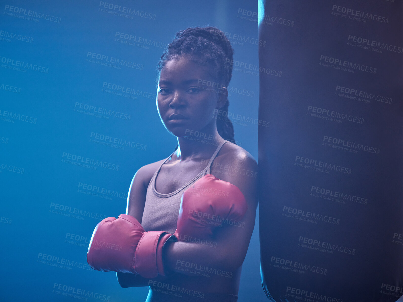 Buy stock photo Fitness, boxer and gym of a black woman in sports professional for strength and motivation. Portrait of a African female in serious and confident boxing at health club standing by punching bag