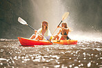 Happy friends kayak on the lake or river together during summer vacation. Free, freedom and rowing women canoeing on a boat and having fun in nature with water activity on weekend at a waterfall