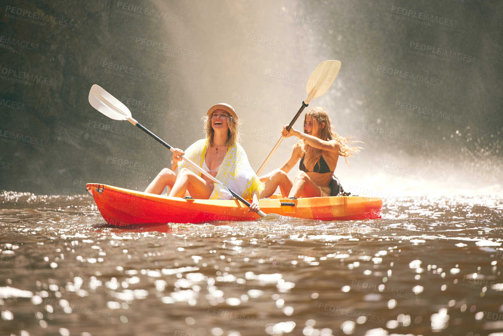 Buy stock photo Happy friends kayak on the lake or river together during summer vacation. Free, freedom and rowing women canoeing on a boat and having fun in nature with water activity on weekend at a waterfall