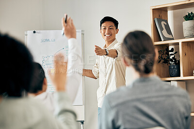 Buy stock photo Businessman doing a presentation in a meeting with his team asking questions in a conference room. Group planning a project on a flip chart in an office. People at a corporate seminar or workshop.