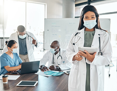 Buy stock photo Doctor with covid face mask and tablet, healthcare worker and medical expert doing research in meeting at hospital and planning schedule online. Portrait of African employee consulting on the web