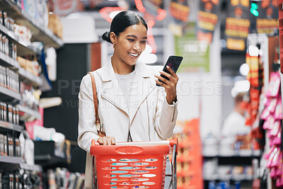 Buy stock photo Phone, 5g internet and grocery shopping Indian woman reading a funny text or social media content. Comic web, mobile and online scroll at a retail food store with a happy customer smile from India 