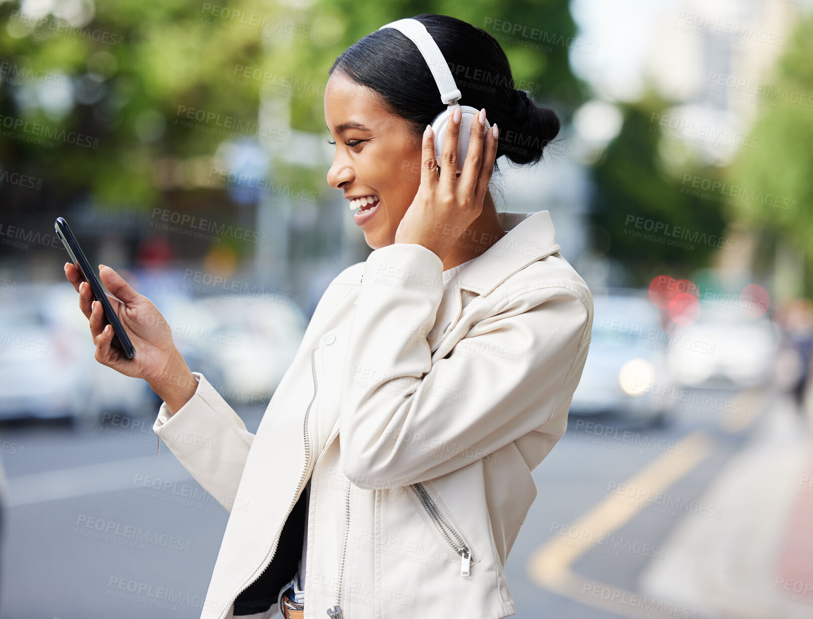 Buy stock photo Happy city girl with phone and headphones on video call while walking relax in the street to work or home. Black woman or student laughing at joke, meme or online video while on travel to a location