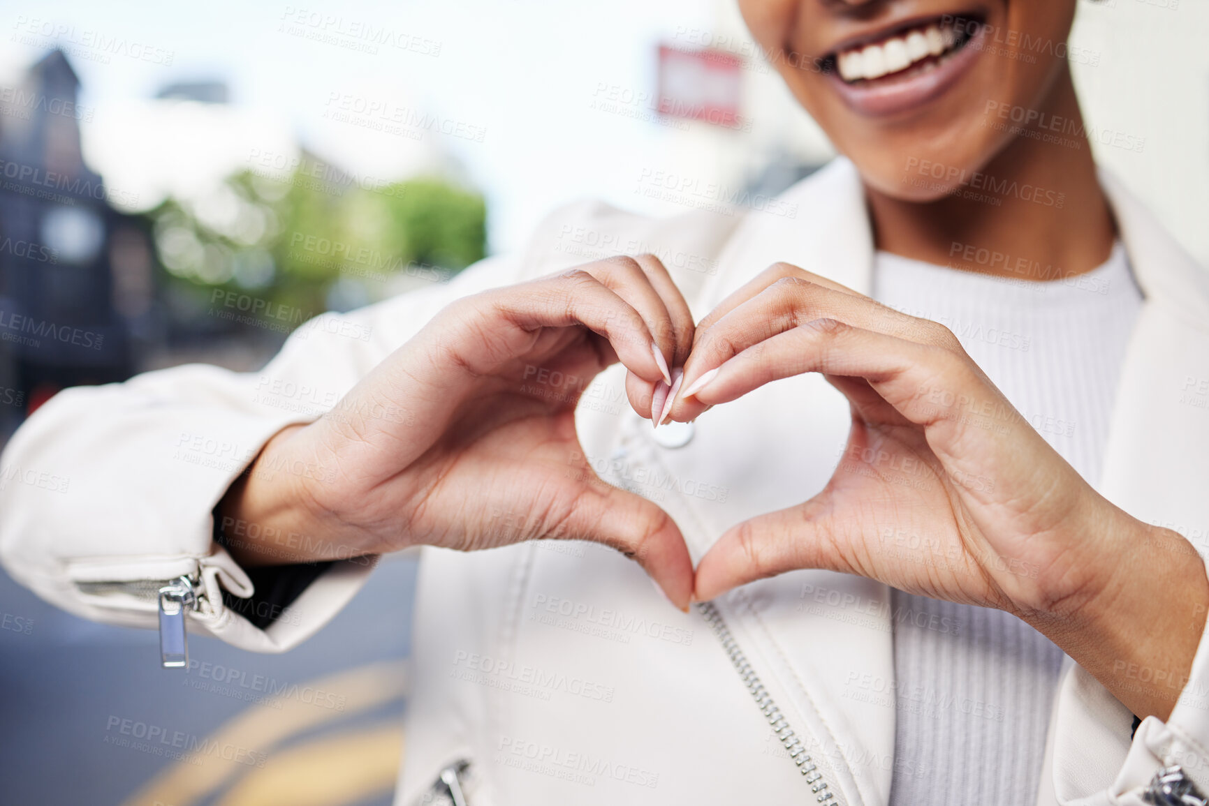 Buy stock photo Hands, heart and sign of a black woman with smile in care, support and joy against city background. Happy African American female happy and smiling with love gesture or hand sign at a urban town