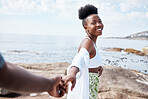 Beach, travel and holiday, black couple holding hands while on a walking at the ocean. Nature, love and freedom on the weekend, a man and woman on a ocean walk. Vacation, summer and a smile with POV.
