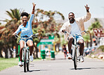 African couple cycling on bike on vacation, peace hand sign on bicycle for sustainable lifestyle in the city and happy on holiday in summer for travel. Eco friendly man and woman in Miami for spring