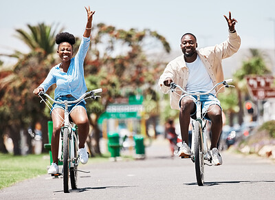 Buy stock photo African couple cycling on bike on vacation, peace hand sign on bicycle for sustainable lifestyle in the city and happy on holiday in summer for travel. Eco friendly man and woman in Miami for spring