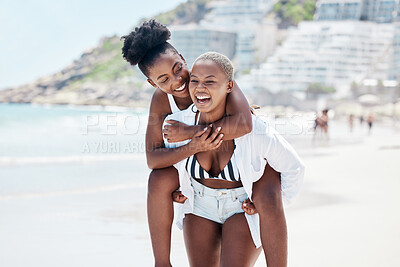 Buy stock photo LGBTQ, gay and lesbian black women enjoying a piggyback ride and fun at beach in summer. Friends, dating and trust with female and her girlfriend on holiday, vacation or travel by the coast