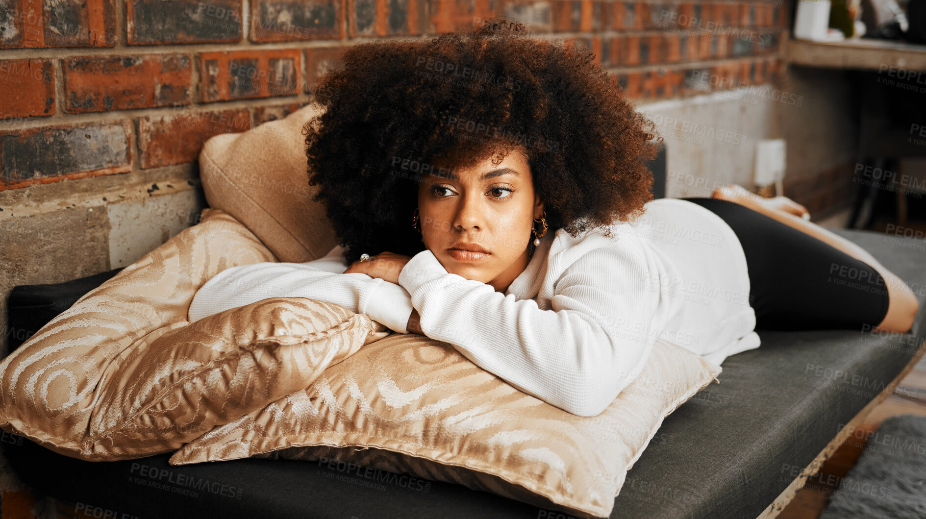 Buy stock photo Sad, tired and depressed African woman thinking with burnout, anxiety and depression on the sofa in the living room in home. Girl with mental health problem with idea, in fear and trauma in house