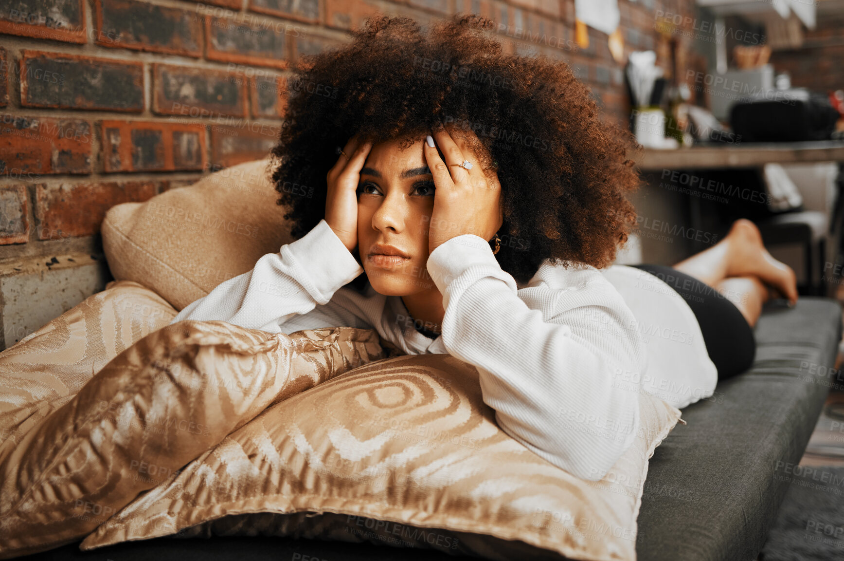 Buy stock photo Depressed, sad and frustrated African woman thinking of idea with anxiety, problem with mental health and depression on the sofa in home. Frustrated, fear and tired girl with stress  on house couch