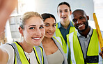 Group of industrial workers taking a selfie on a phone while working in a warehouse factory. Portrait of industry engineers taking picture on smartphone in office while planning project at work site.