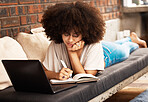 Education, learning and writing with a woman student studying online with her laptop on a sofa in her home living room. Study, growth and development with a female learner taking notes for an exam